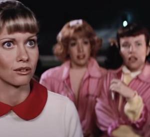 Pink Ladies and Sandy looking stunned in Grease.