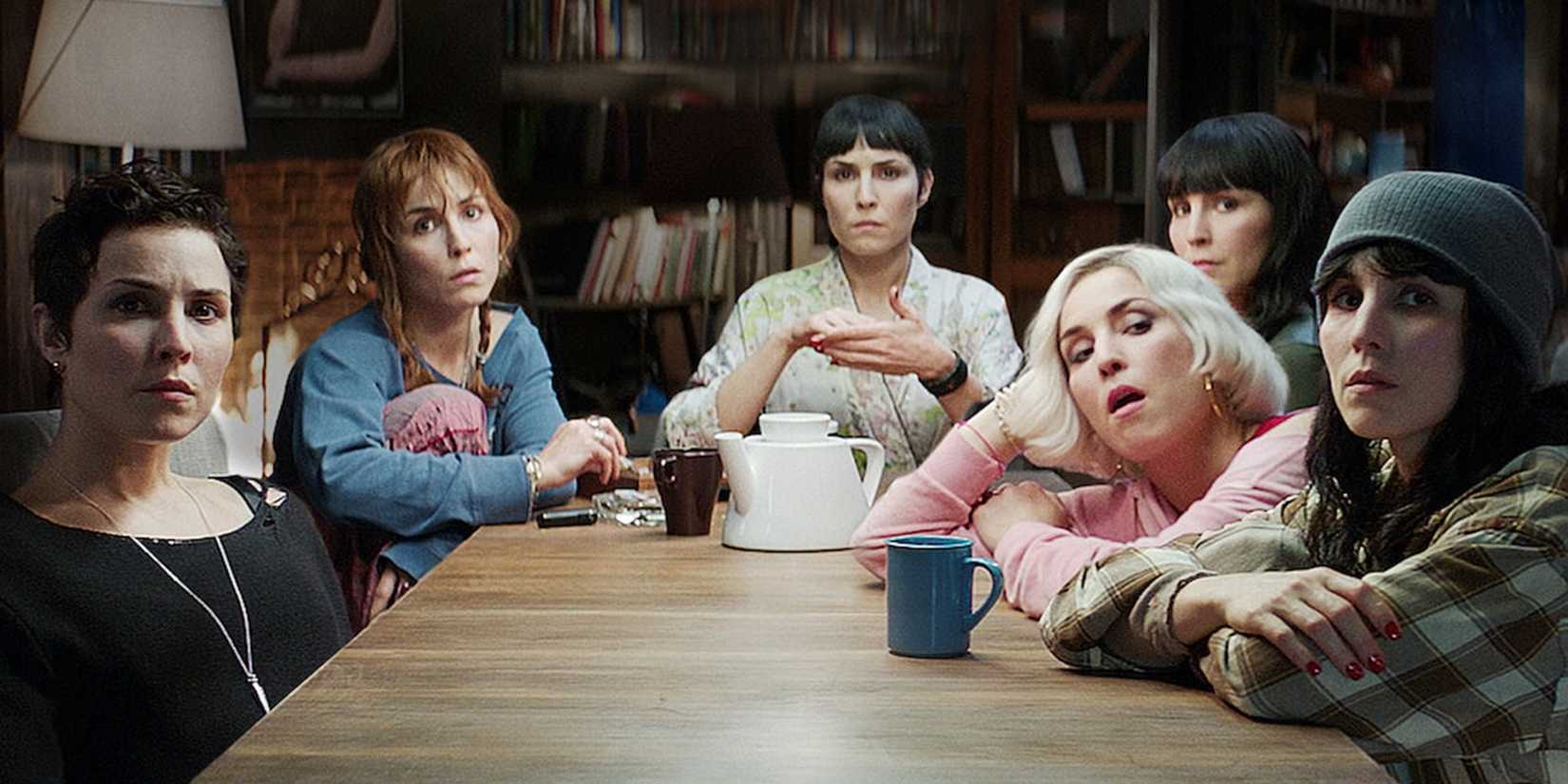 Septuplets sitting at a table in What Happened to Monday