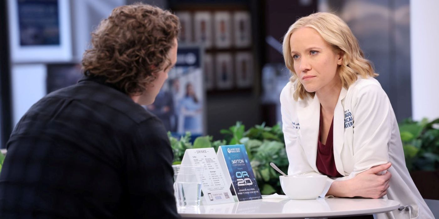 Hannah Asher and Sean Archer sit at a table in the hospital in Chicago Med season 8, episode 20.