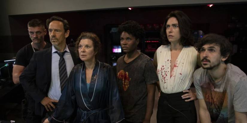 The crew of a reality show stare intently at the monitors in Reality Z