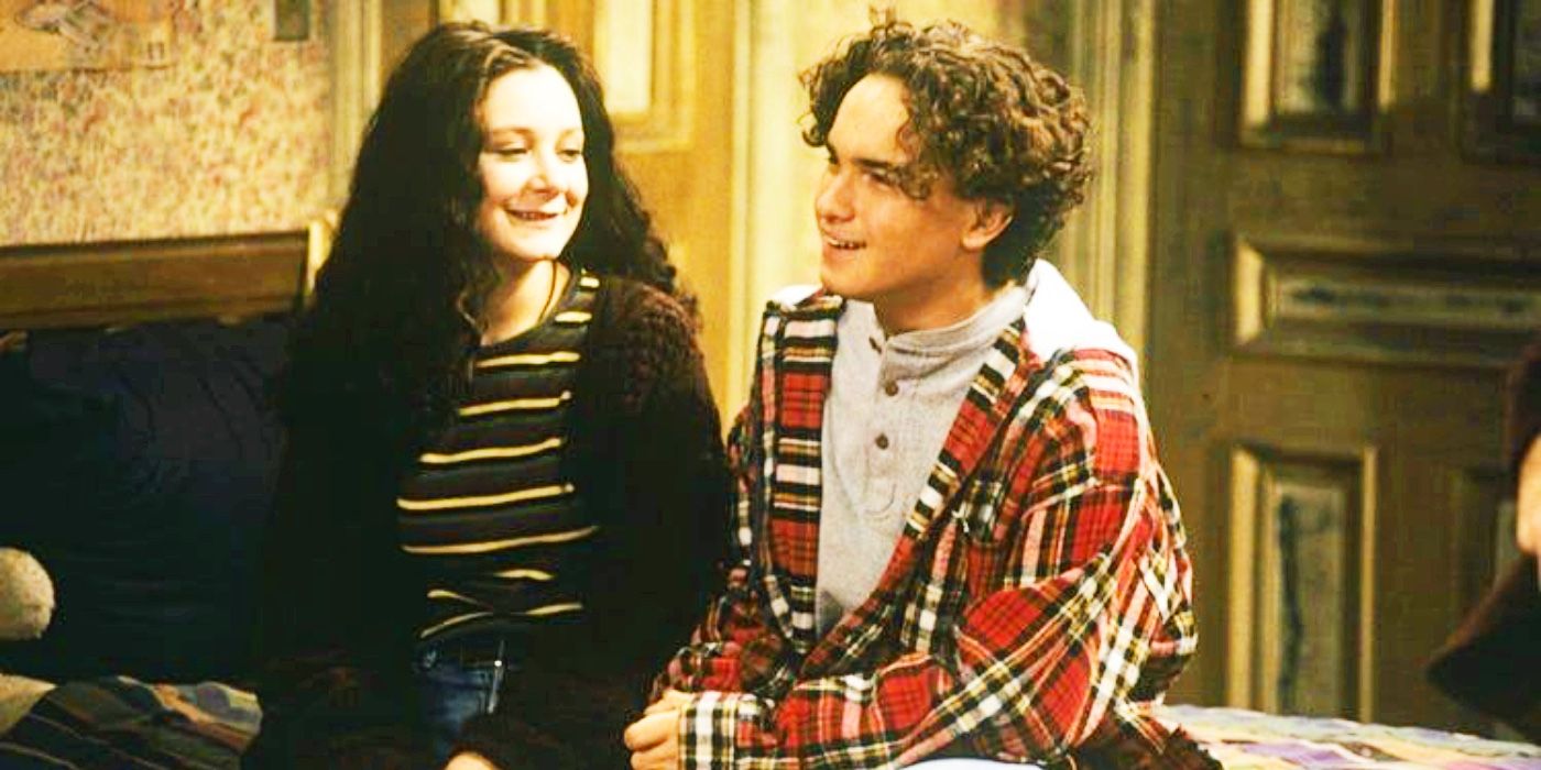 Darlene and David on sitting in a bed and smiling in Roseanne