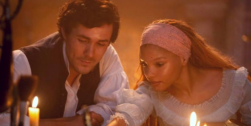Halle Bailey's Ariel and Jonah Hauer-King's Eric lit by candlelight in The Little Mermaid.