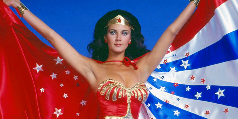 lynda carter as wonder woman with her arms outstretched