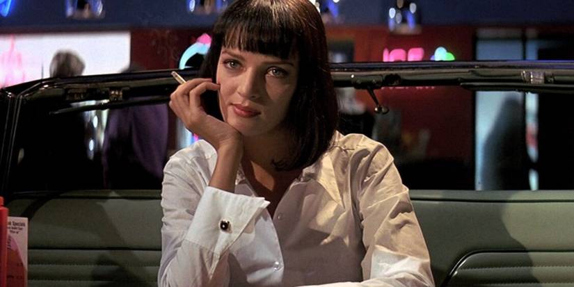 Uma Thurman as Mia Wallace holding a cigarette in Pulp Fiction
