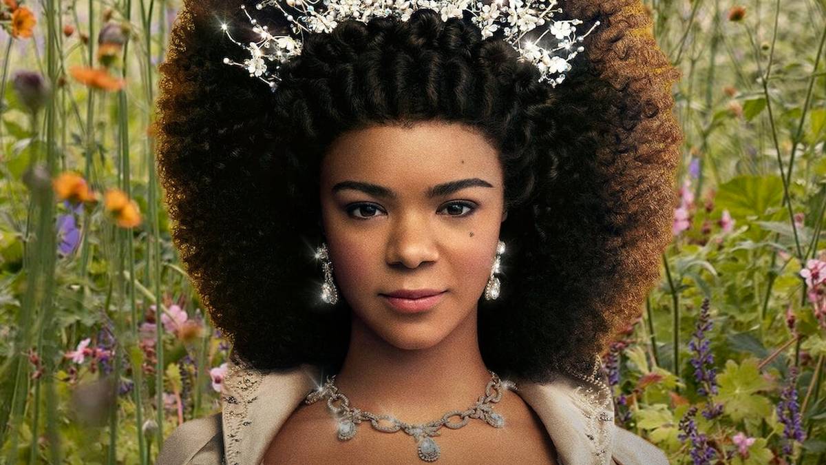 A closeup of the young Queen Charlotte against a field of flowers in the Bridgerton prequel series Queen Charlotte