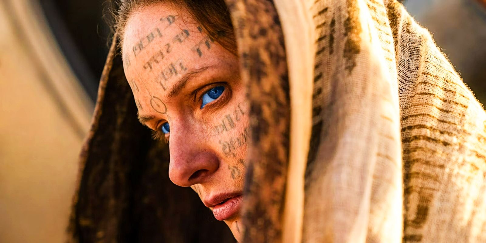 Rebecca Ferguson as Lady Jessica with figures on face in Dune Part 2.