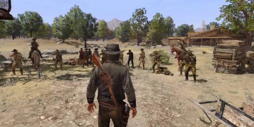 John Marston stands before a group of agents facing his death in Red Dead Redemption.