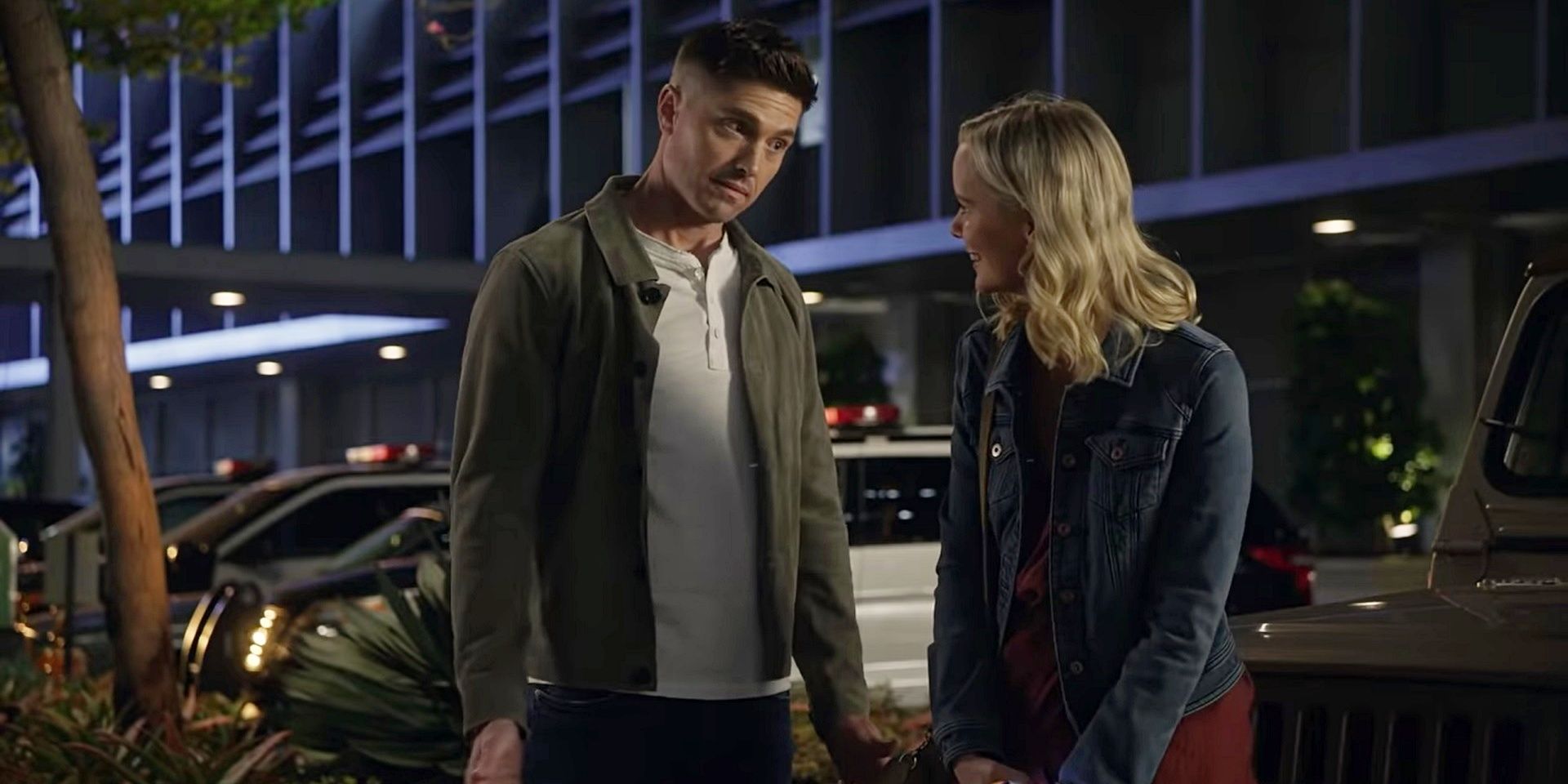 Tim and Ashley stand outside the station in The Rookie season 4.