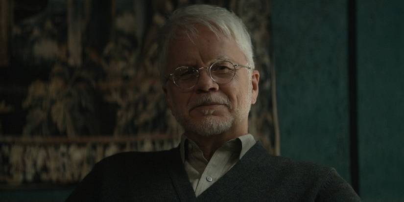 Tim Robbins' Bernard smiling in Silo