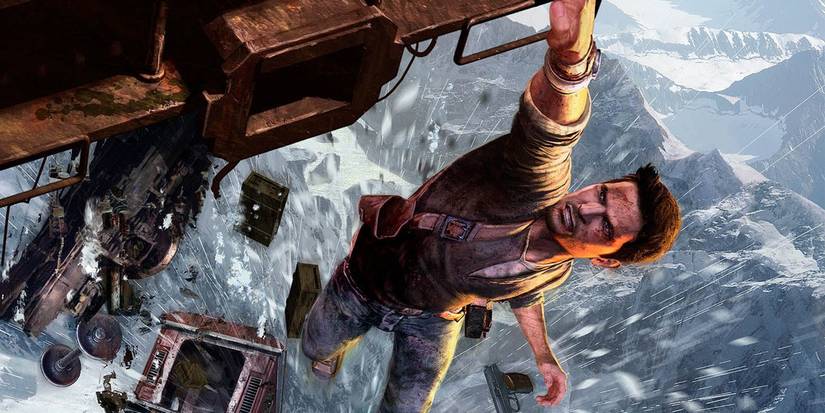 Nathan Drake hangs from a falling train over snowy mountains in Uncharted 2's opening scene
