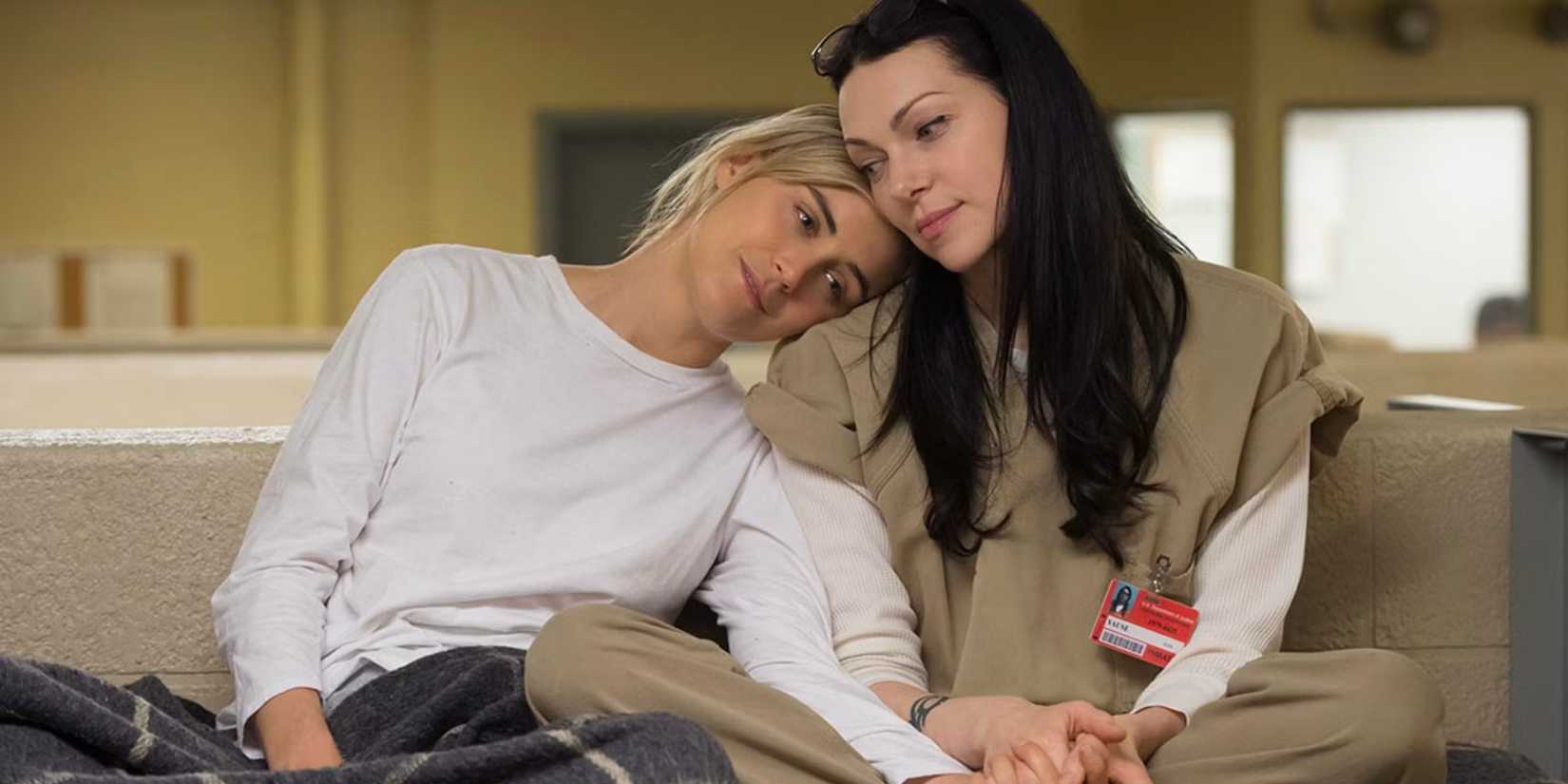 Piper Chapman (Taylor Schilling) with her head on Alex Vause's (Laura Prepon) shoulder as they sit in their bunk together in Orange is the New Black.