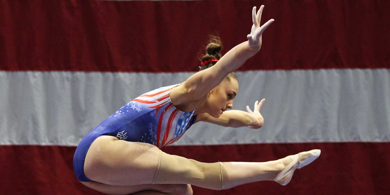 9 Movies Overlooked At The 2021 Awards 4 A gymnast in the air with part of a flag in the background in footage from Athlete A