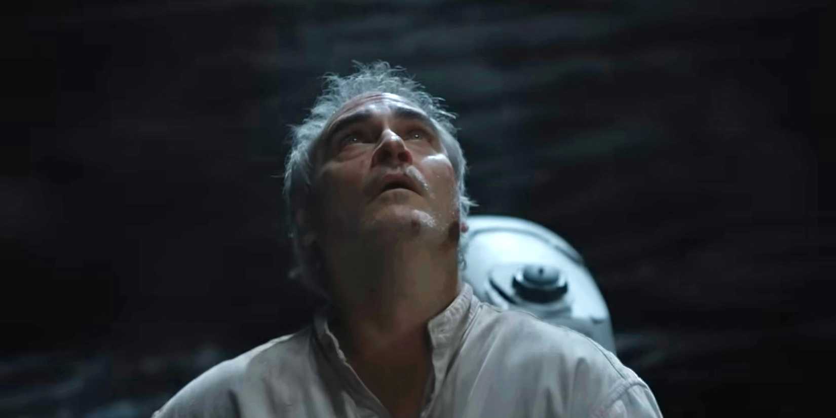Joaquin Phoenix's Beau in a boat looking up in Beau Is Afraid.