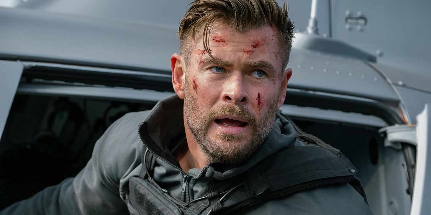 Chris Hemsworth with cuts on his face in a helicopter in Extraction 2