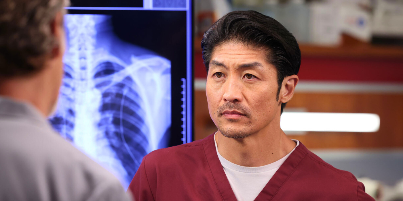 Dr. Ethan Choi in Chicago Med with an X-ray image behind him as he looks someone