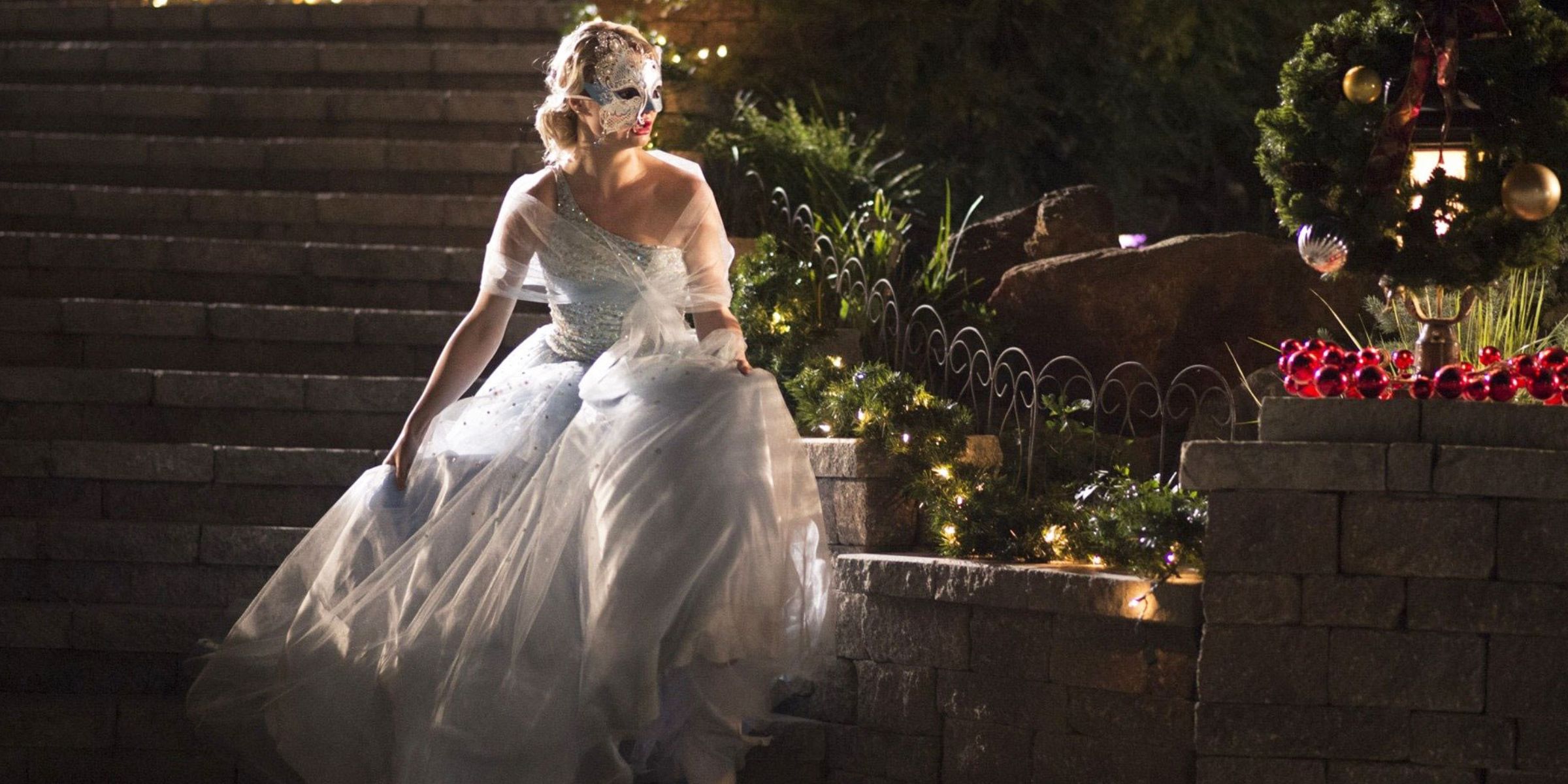 Emma Rigby in a ballgown and masquerade mask in A Christmas Cinderella