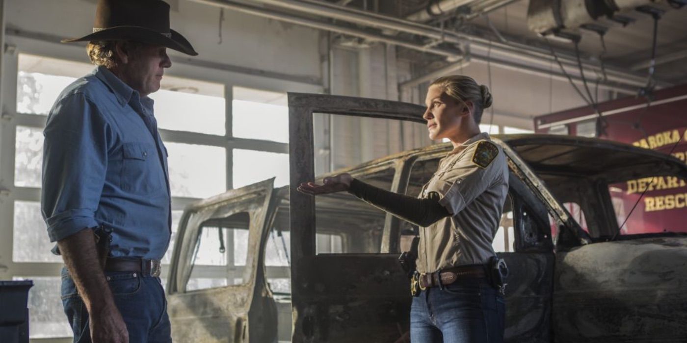 Walt and Vic talk in front of a burned out car in Longmire 
