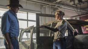 Walt and Vic talk in front of a burned out car in Longmire