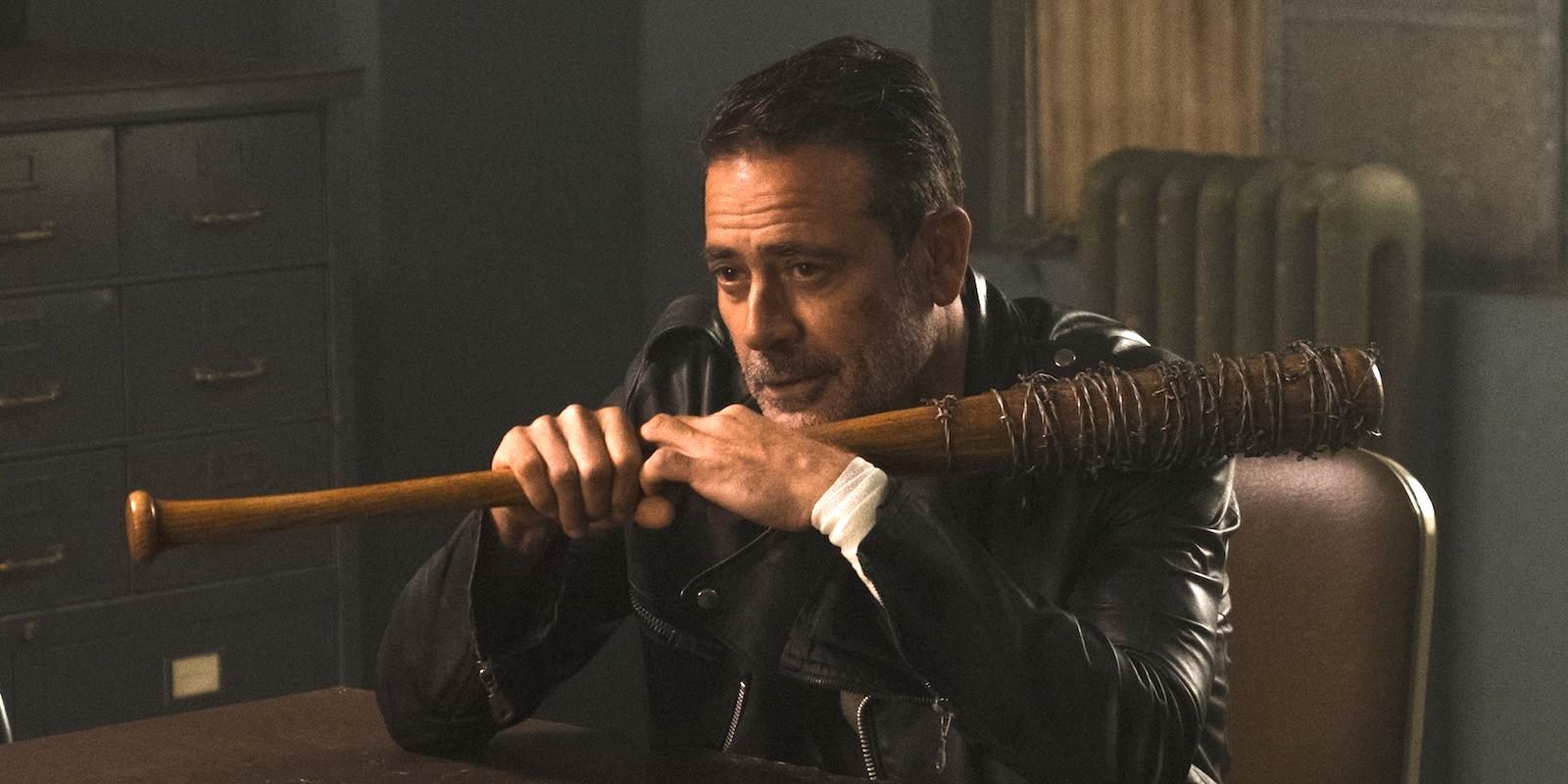 Negan (Jeffrey Dean Morgan) sitting holding Lucille in The Walking Dead