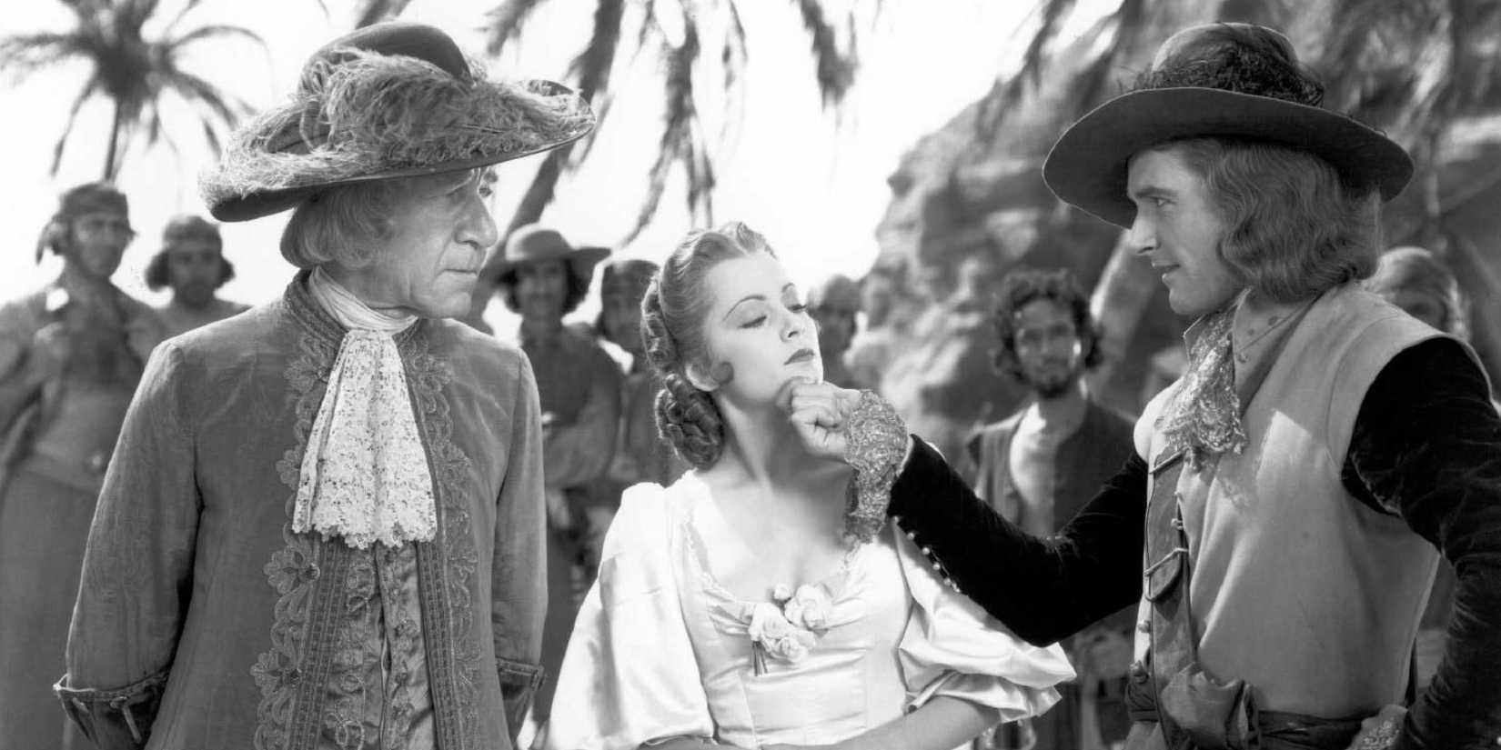 A black and white still of Captain Blood with the group on a beach