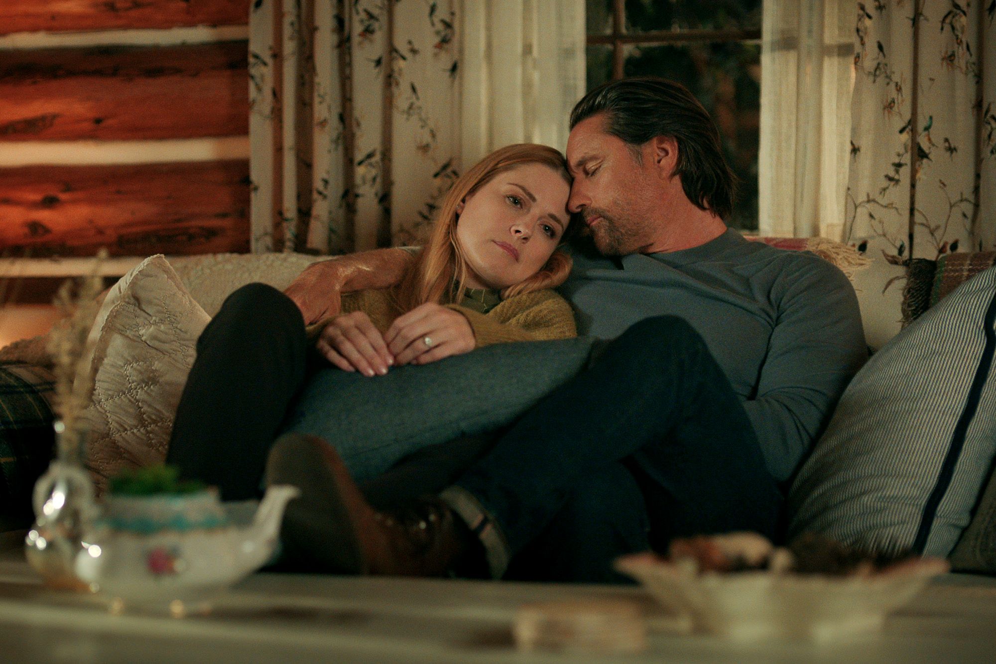 Alexandra Breckenridge and Martin Henderson in Virgin River season 5 on a couch