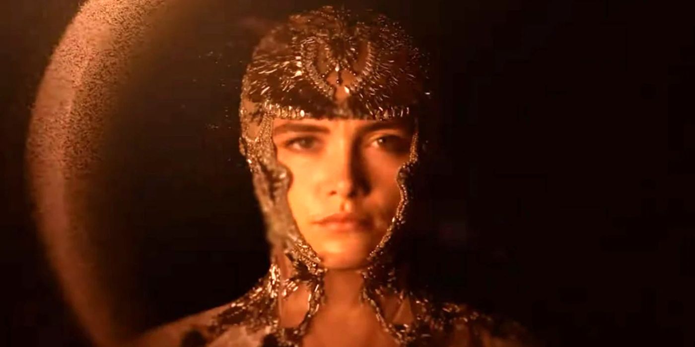 Florence Pugh as Princess Irulan in Dune: Part Two. She's wearing a gem-covered outfit that outlines her face.
