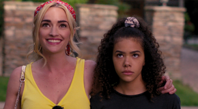 Georgia (Brianne Howey) smiling with her arm around a frowning Ginny (Antonia Gentry) in Ginny & Georgia