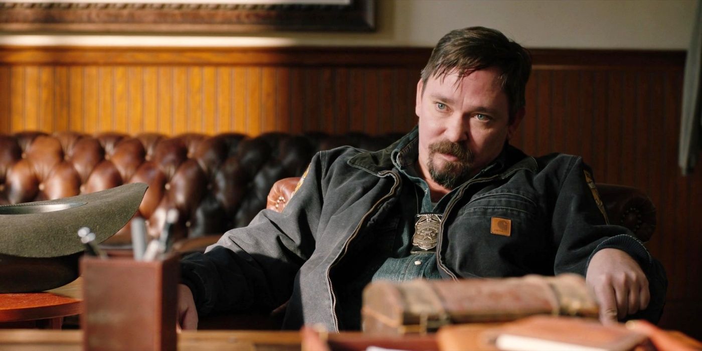 James Jordan as Agent Steve Hendon sitting on a leather couch in Yellowstone.