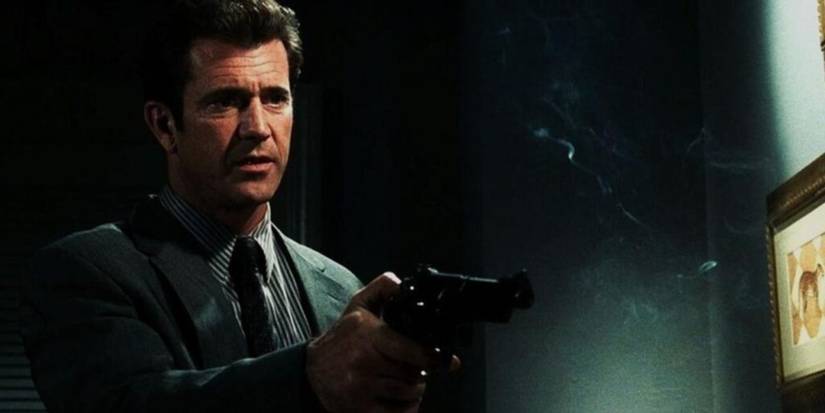 Mel Gibson disparando uma arma em Payback