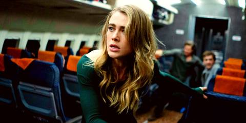 Melissa Roxburgh looking alarmed while in the airplane aisle in Manifest season 4