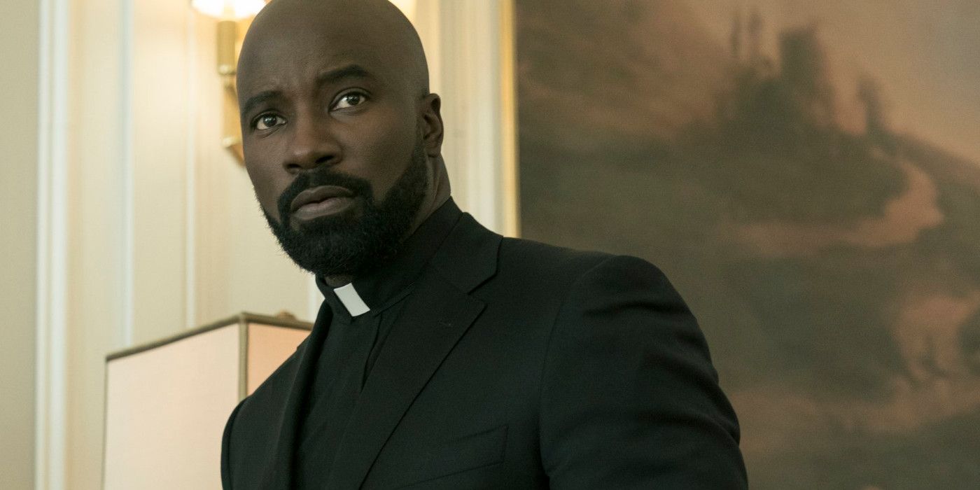 Mike Colter as Father David Acosta giving a stern look in Evil season 3