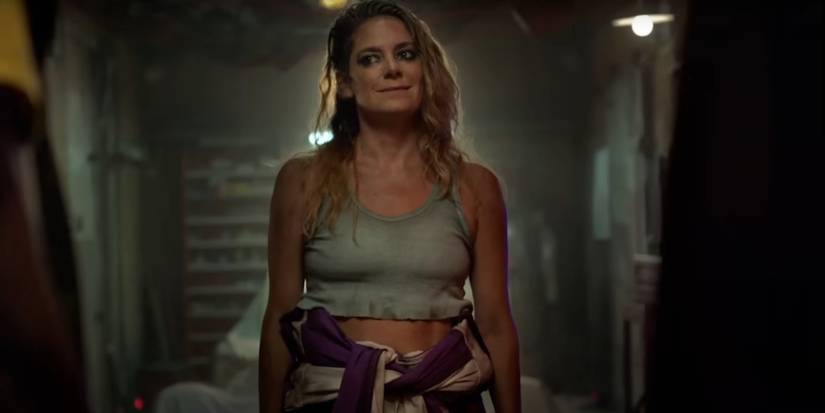 Miranda Watts smirks in a dark hallway in Twisted Metal