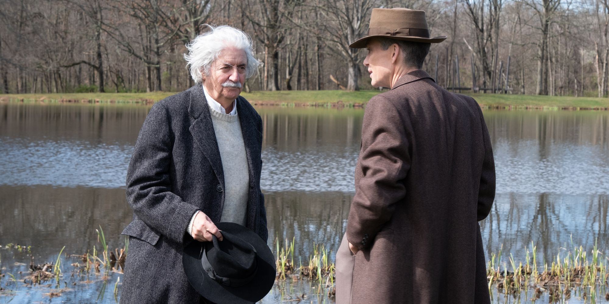 Einstein and Oppenheimer talking by a lake in Oppenheimer