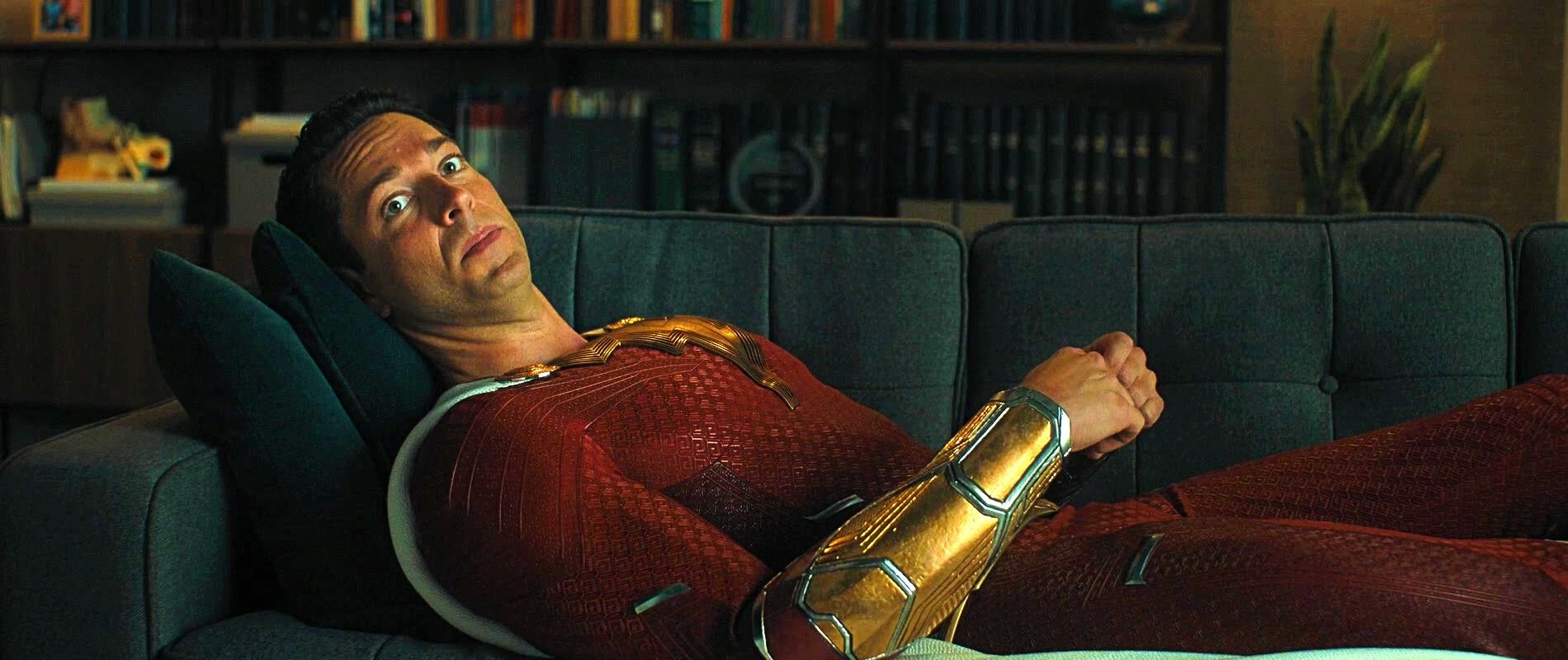 Shazam 2 scene of Zachary Levi's Shazam lying down on a psychiatrist's couch.