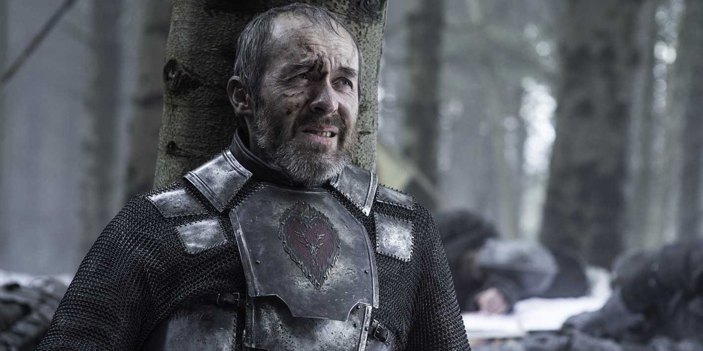 Stannis leans on a tree in Game of Thrones