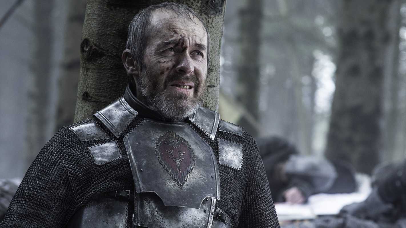 Stannis leans on a tree in Game of Thrones