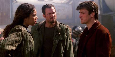 Gina Torres as Zoe, Adam Baldwin as Jayne, and Nathan Fillion as Mal discussing work and bills in Firefly