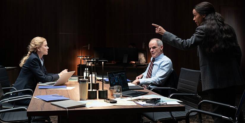 Zoe Saldana talking to Nicole Kidman and Michael Kelly in a conference room in Special Ops Lioness