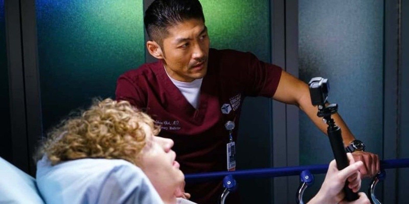 Brian Tee as Dr. Choi and Jack Lancaster as Dennis holding a camera in Chicago Med Season 5 Episode 8