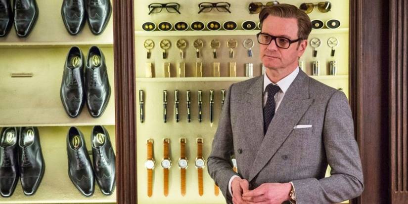 Harry stands in front of a wall of shoes, watches, and various other accessories in Kingsman