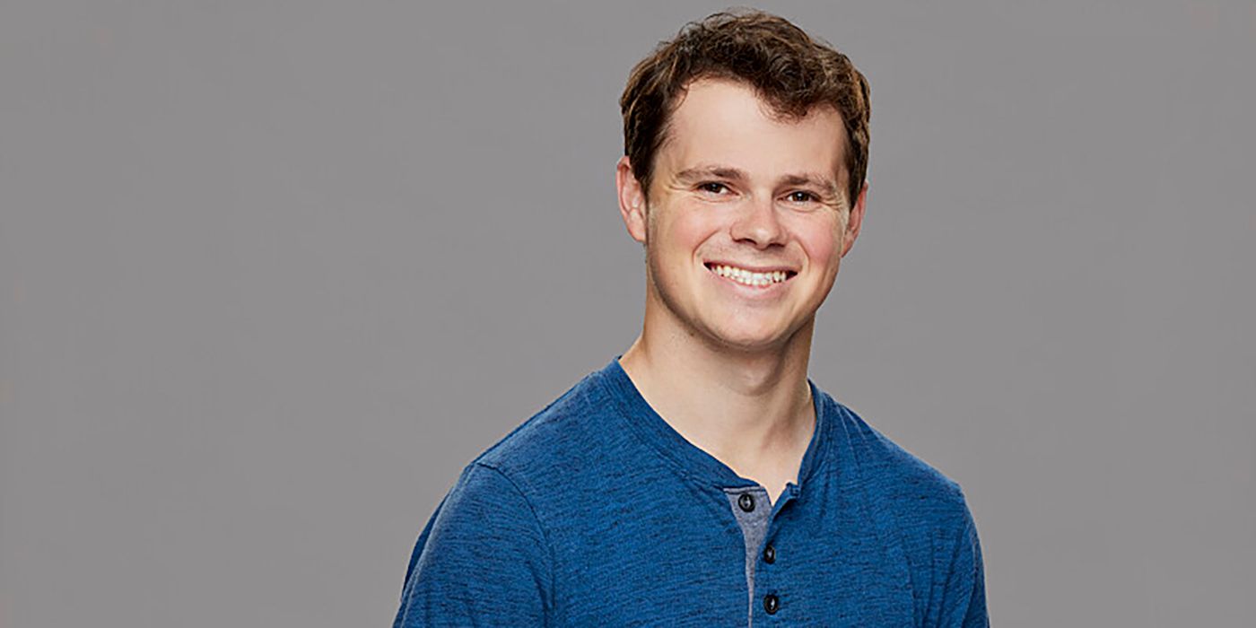 Cory Wurtenberger Big Brother wearing blue shirt smiling gray background