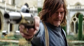 Daryl Dixon pointing a gun off camera and looking beat