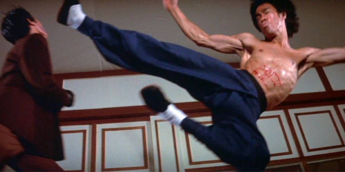 A wounded Lee launching a flying kick against Han's face in Enter the Dragon's climactic fight scene
