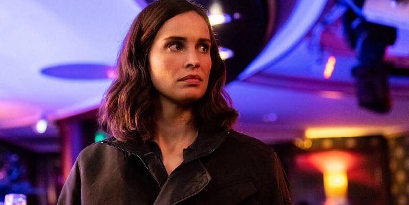 Heida Reed as Jamie Kellett in front of neon lights in FBI: International.