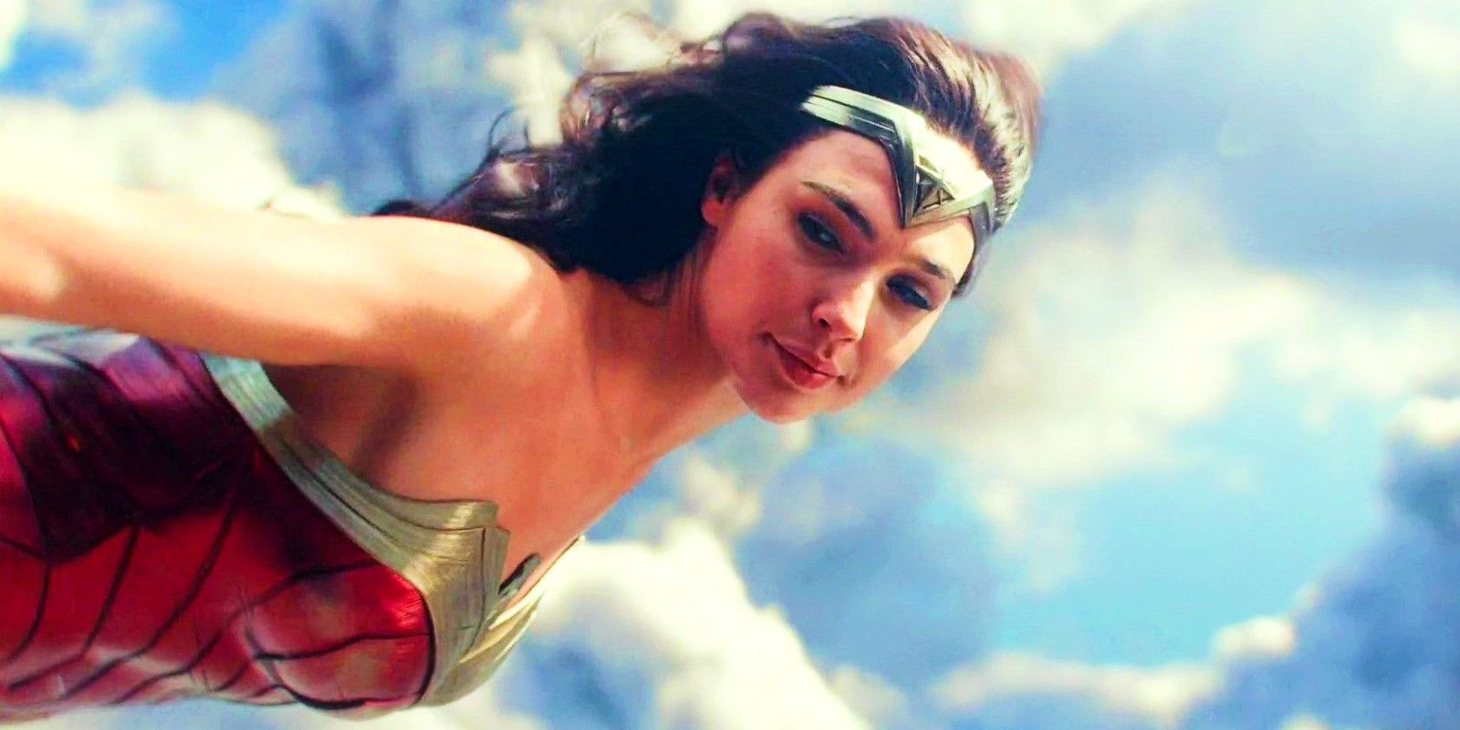 Gal Gadot as Wonder Woman flying through the clouds in Wonder Woman 1984