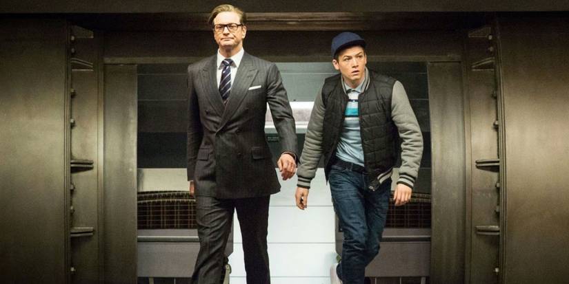 Eggsy swaggers as he walks with Harry into the headquarters in Kingsman