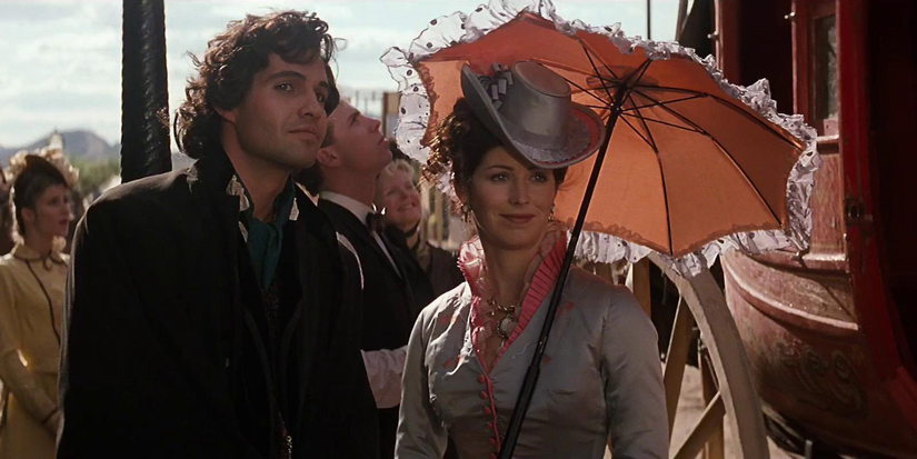 Billy Zane and Dana Delany smiling in the street in Tombstone