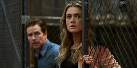 Michaela and Ben Stone looking offscreen from behind a gate in the Manifest series finale. 