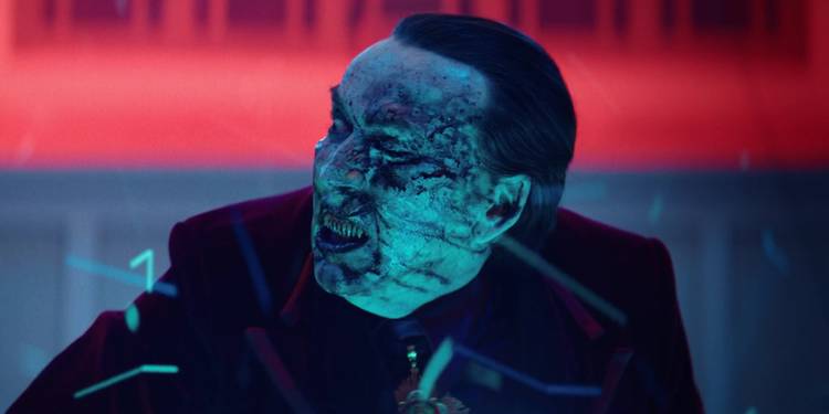 nicolas-cage-as-dracula-in-renfield-with-a-melting-face Nicolas Cage’s Blood-Soaked Horror Adaptation Officially Enters A New Streaming Era