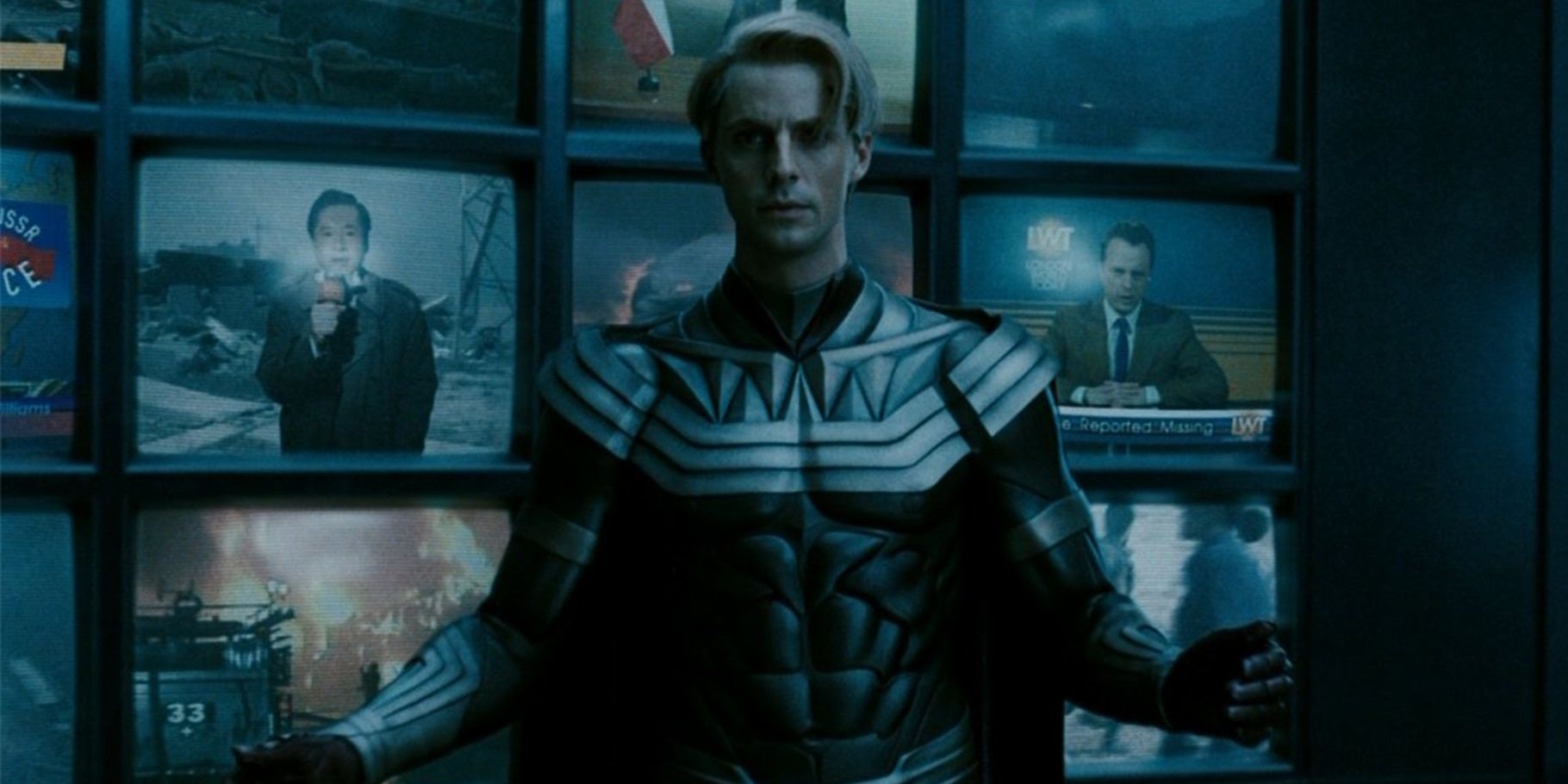Ozymandias (Matthew Goode) standing in front of TV screens in Watchmen
